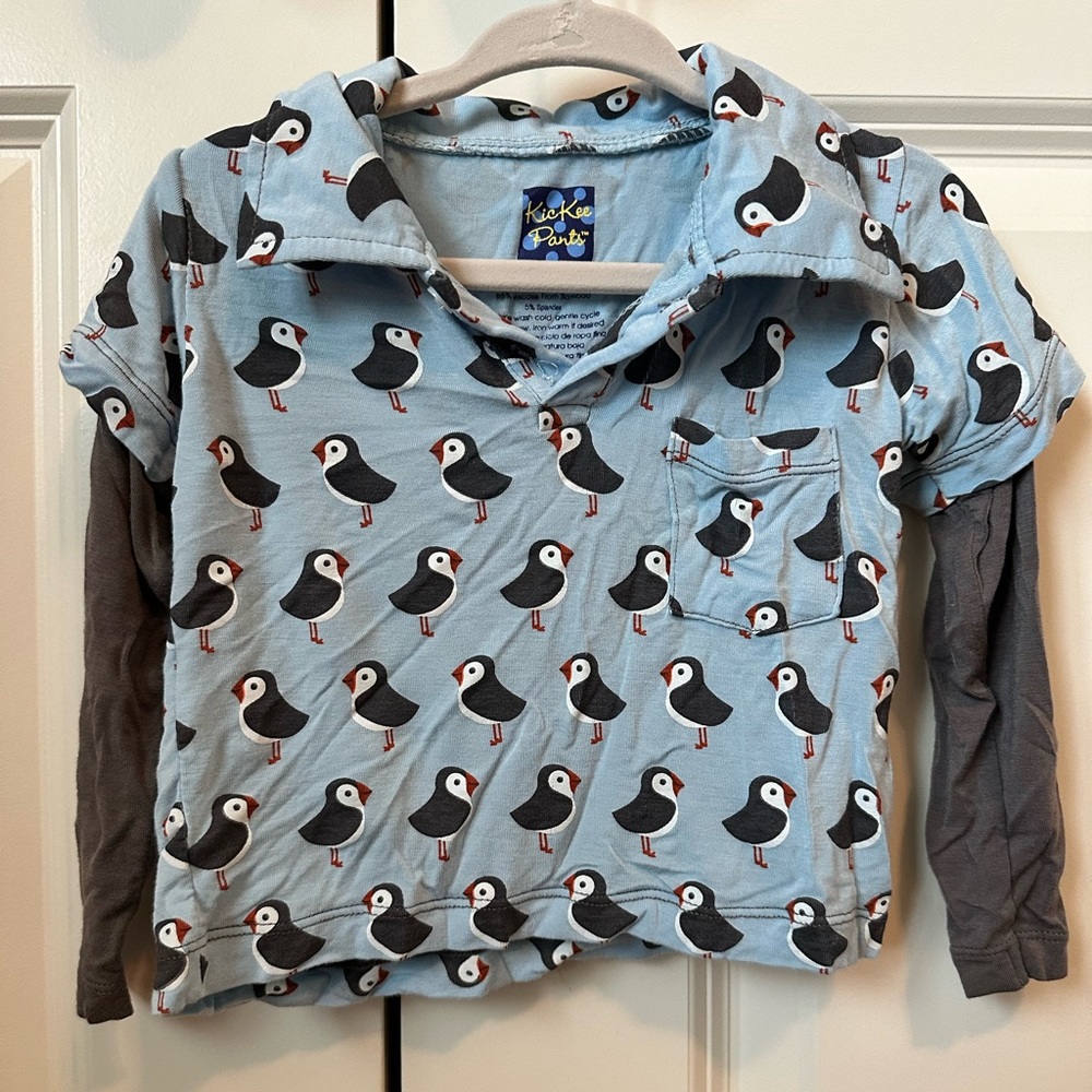 Kickee pants 12-18 mo puffin long sleeve. one button missing. Small sleeve stain